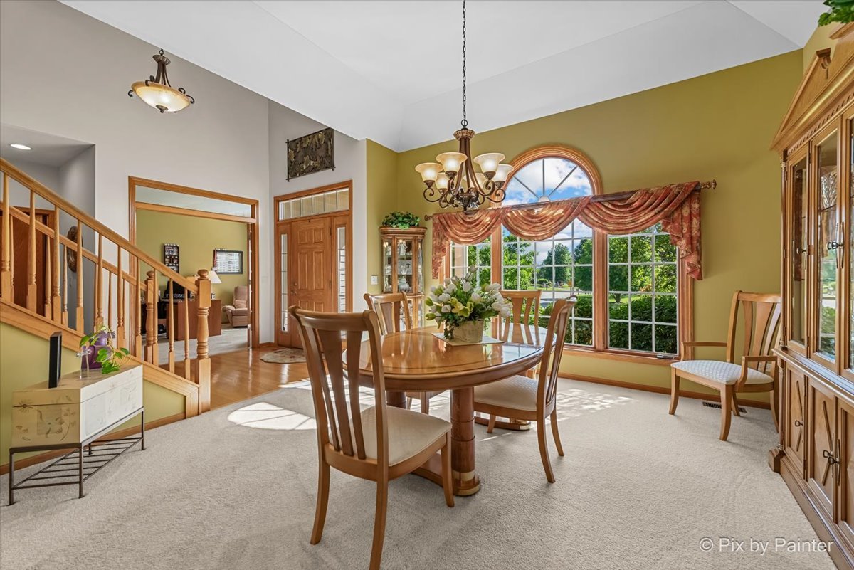 3720 Cypress Drive Spring Grove, IL 60071 - Photo 8 of 55 a view of a dining room and hall with furniture