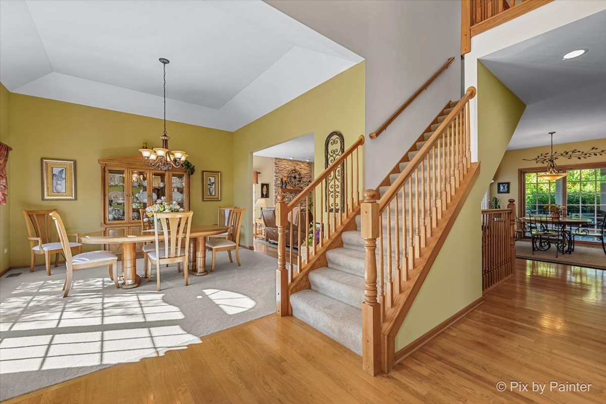 3720 Cypress Drive Spring Grove, IL 60071 - Photo 9 of 55 a view of a dining room with furniture wooden floor and chandelier