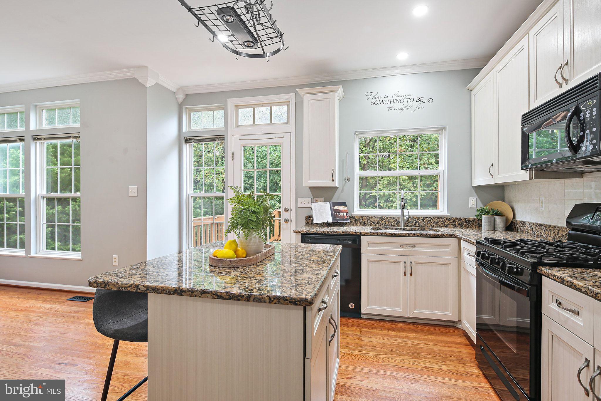 322 Timberbrook Court Odenton, MD 21113 - Photo 11 of 31 a kitchen with granite countertop a stove a sink and a granite counter tops