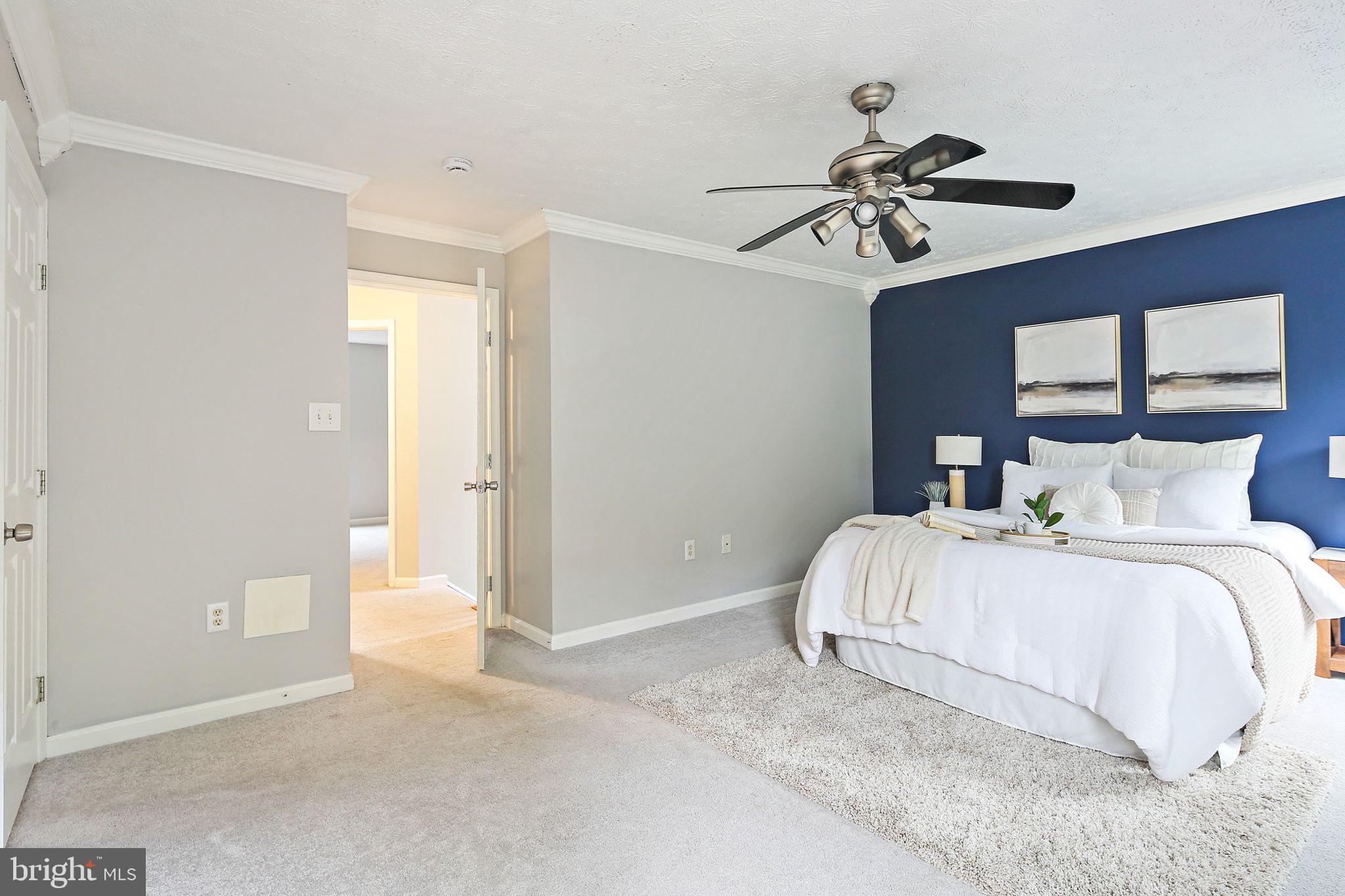 322 Timberbrook Court Odenton, MD 21113 - Photo 15 of 31 a bedroom with a bed and a chandelier