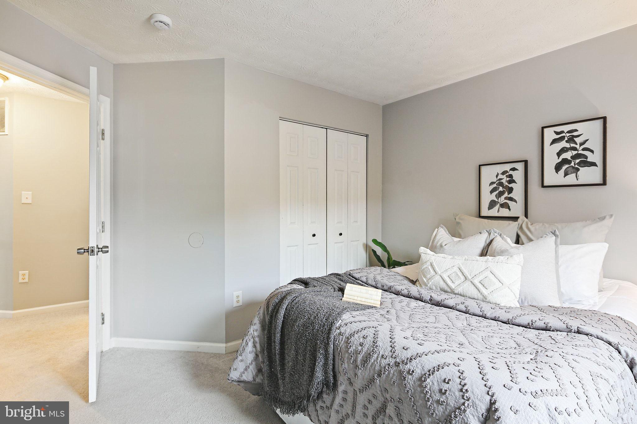 322 Timberbrook Court Odenton, MD 21113 - Photo 21 of 31 a bedroom with a bed and painting on the wall