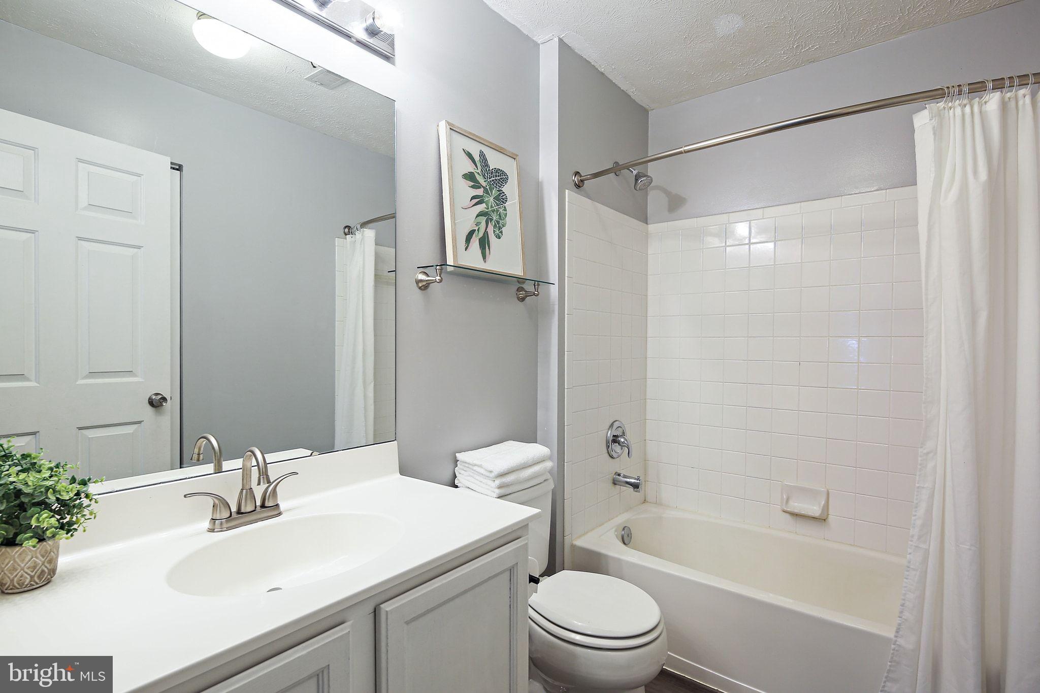 322 Timberbrook Court Odenton, MD 21113 - Photo 24 of 31 a bathroom with a bathtub shower sink vanity mirror and toilet