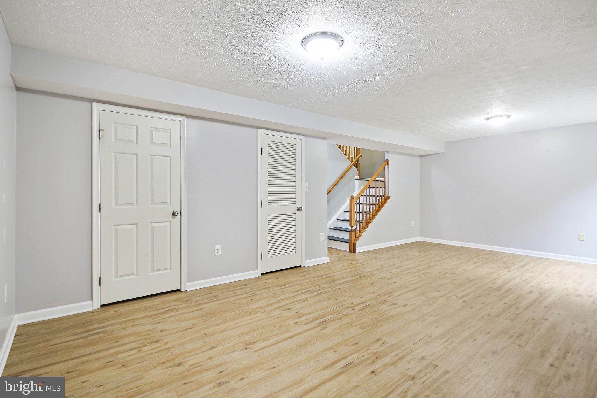 322 Timberbrook Court Odenton, MD 21113 - Photo 25 of 31 a view of an empty room with wooden floor and stairs