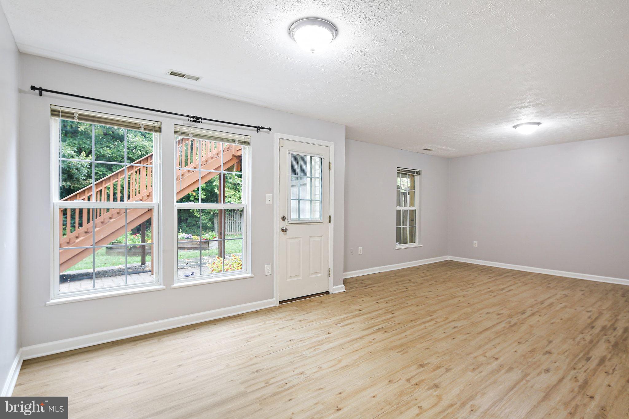 322 Timberbrook Court Odenton, MD 21113 - Photo 26 of 31 an empty room with wooden floor and windows