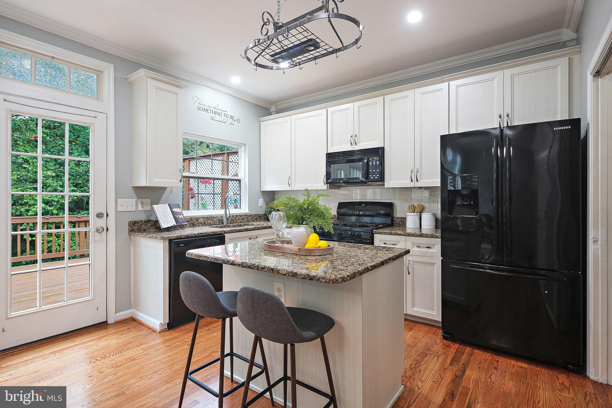 322 Timberbrook Court Odenton, MD 21113 - Photo 10 of 31 a kitchen with stainless steel appliances granite countertop a refrigerator a stove a sink dishwasher and a refrigerator with wooden floor