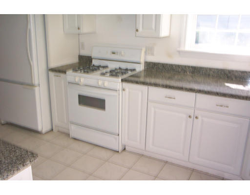 121 Hackensack Road Boston, MA 02467 - Photo 3 of 9 a kitchen with granite countertop white cabinets and white appliances