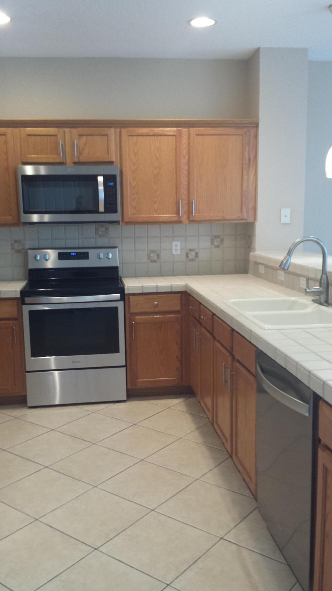 3027 North Evergreen Circle, Unit 3027 Boynton Beach, FL 33426 - Photo 11 of 35 a kitchen with stainless steel appliances granite countertop a sink and a stove