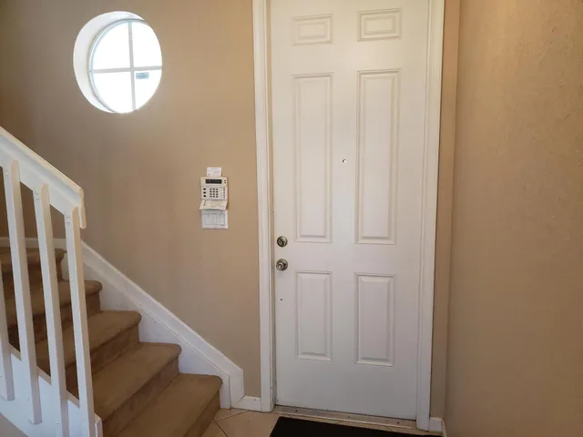 a view of staircase and hallway with wooden floor