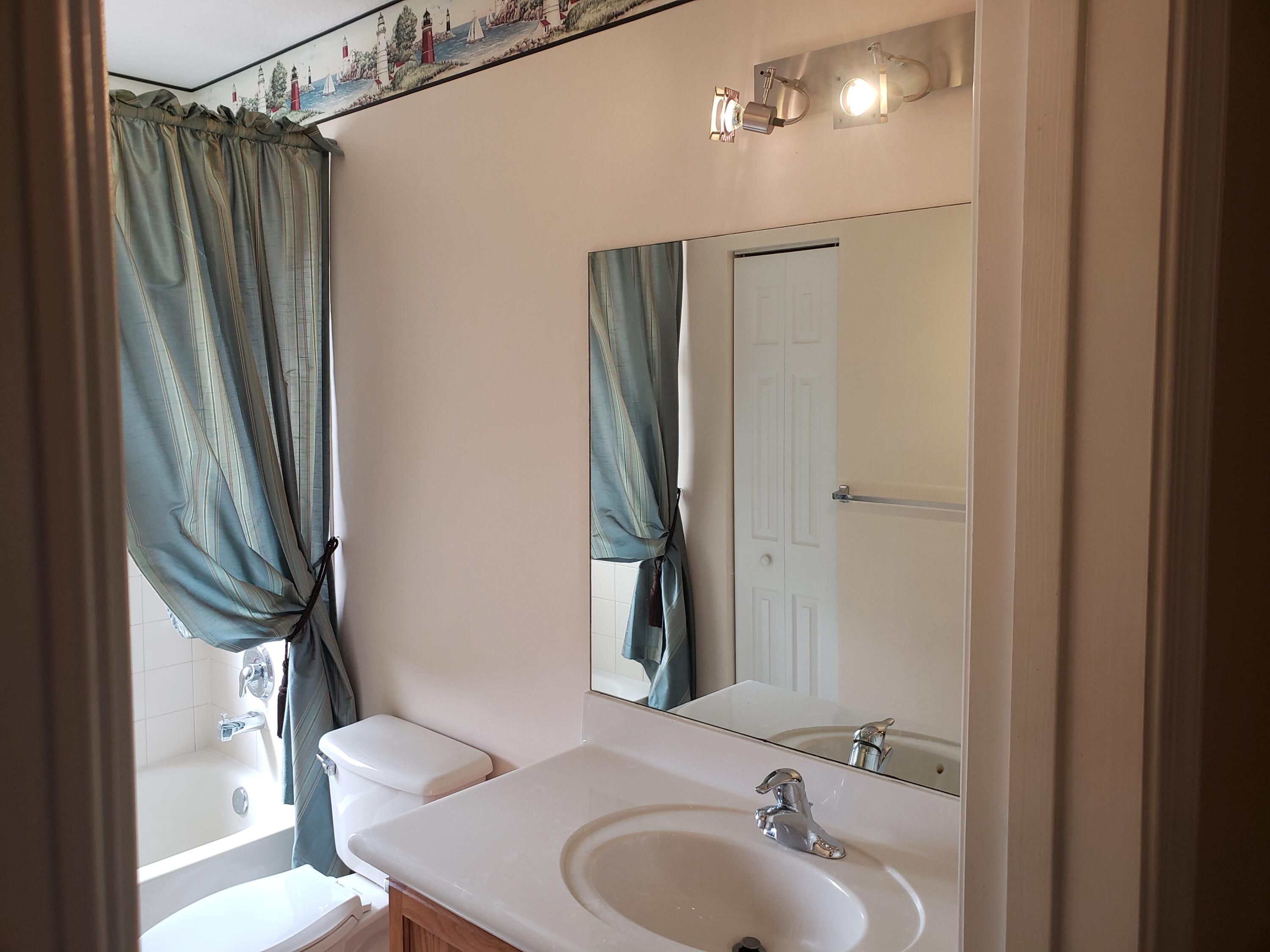 3027 North Evergreen Circle, Unit 3027 Boynton Beach, FL 33426 - Photo 15 of 35 a bathroom with a sink toilet and shower