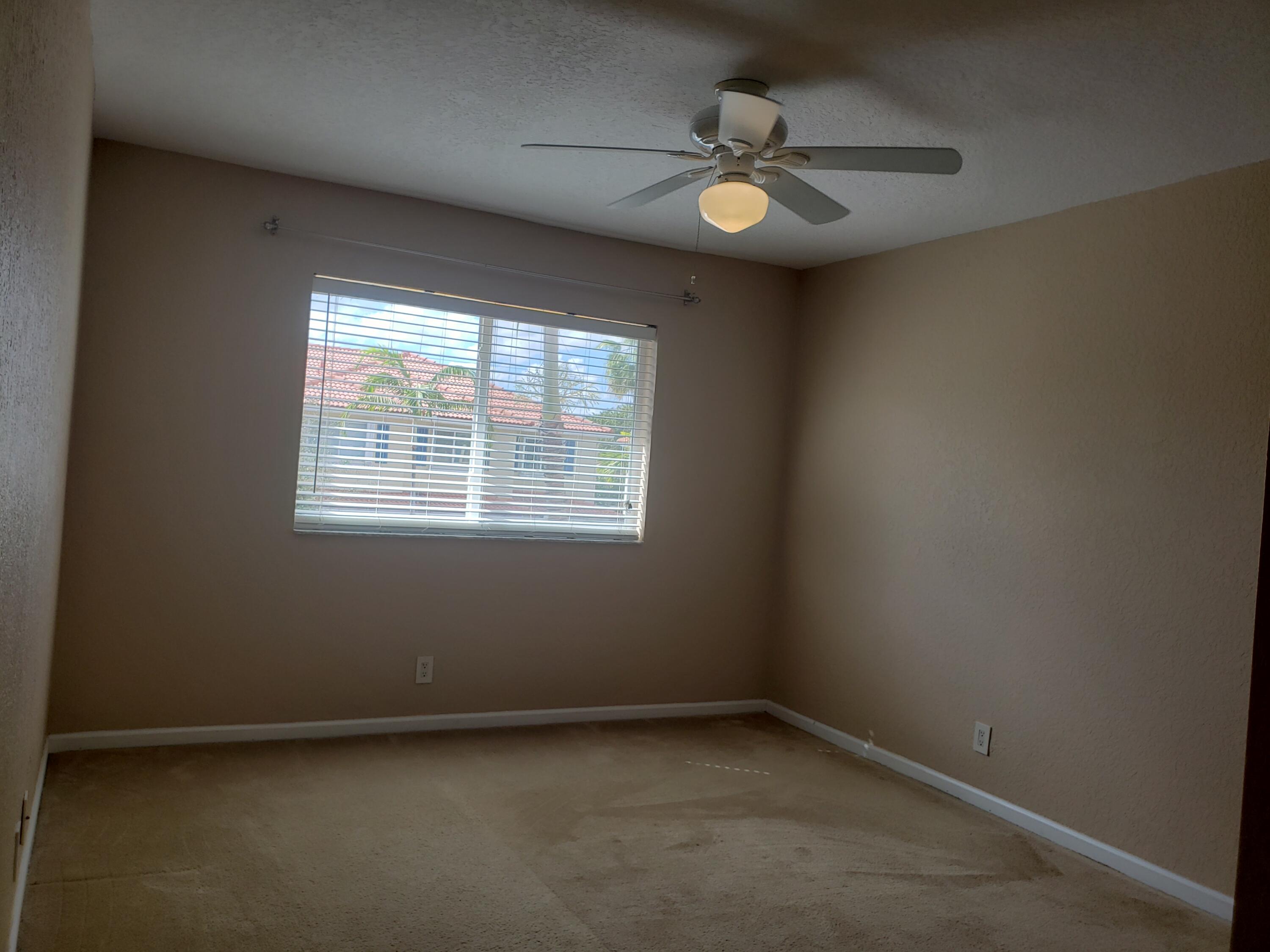 3027 North Evergreen Circle, Unit 3027 Boynton Beach, FL 33426 - Photo 19 of 35 an empty room with a window