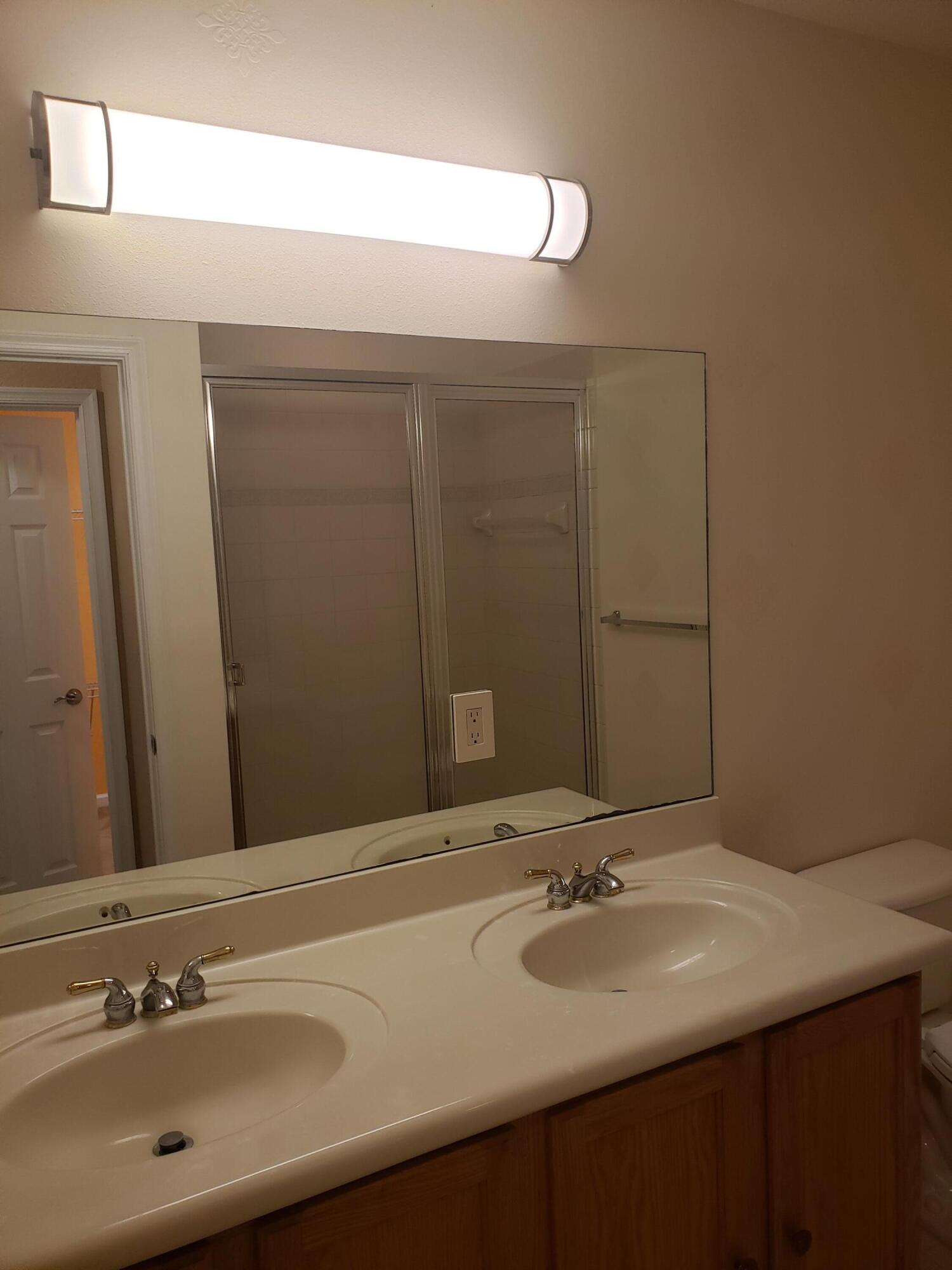 3027 North Evergreen Circle, Unit 3027 Boynton Beach, FL 33426 - Photo 26 of 35 a bathroom with a sink and a mirror