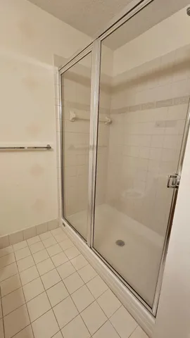 a bathroom with a glass shower door