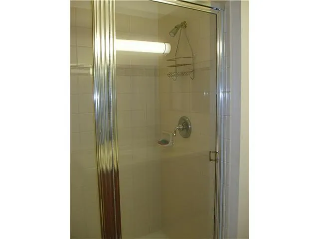 a bathroom with a glass shower door