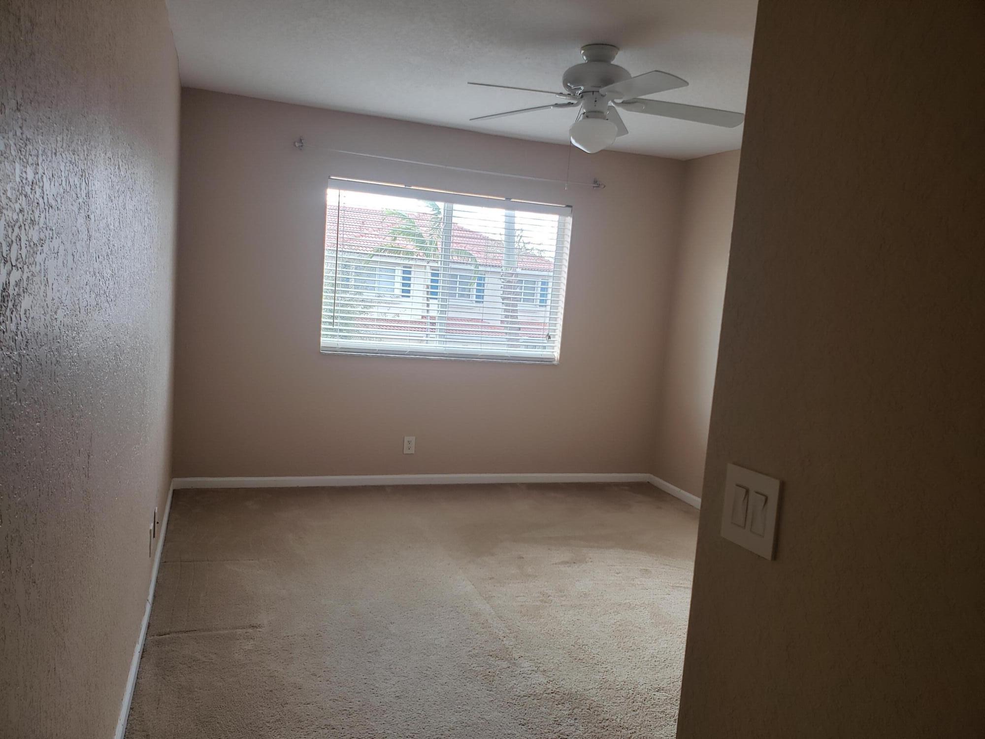 3027 North Evergreen Circle, Unit 3027 Boynton Beach, FL 33426 - Photo 29 of 35 an empty room with a window
