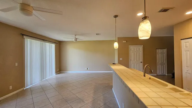 a spacious bathroom with a granite countertop sink mirror and vanity
