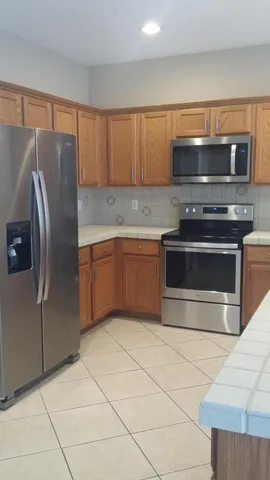 a kitchen with granite countertop a stove and a refrigerator