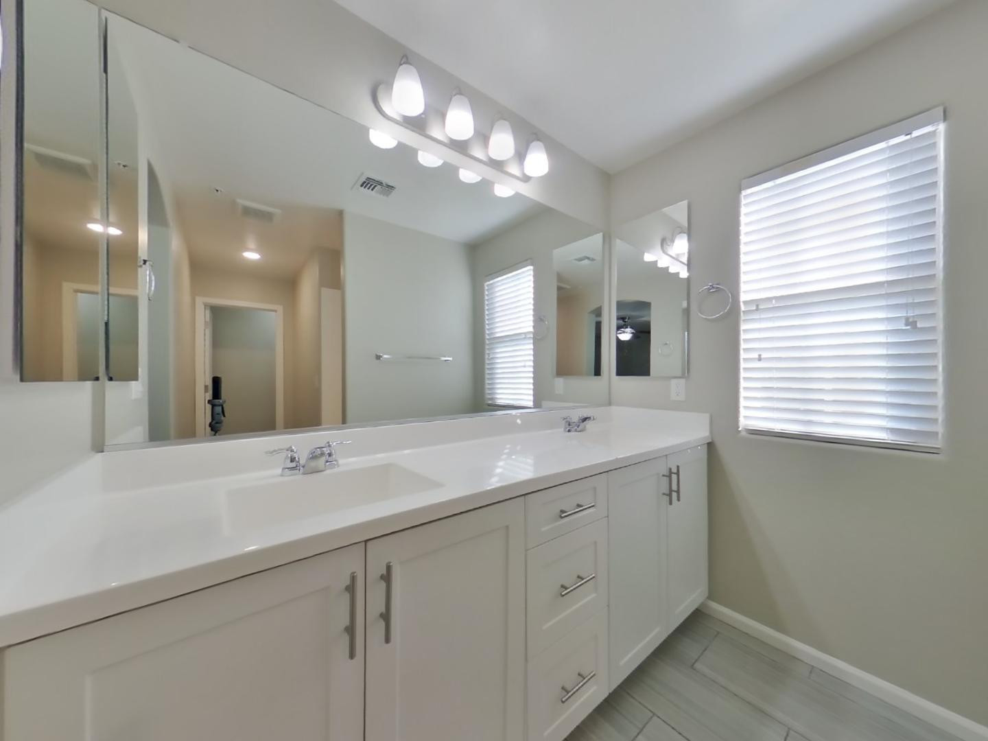 12565 West Via Dona Road Peoria, AZ 85383 - Photo 8 of 17 a bathroom with a double vanity sink and a mirror