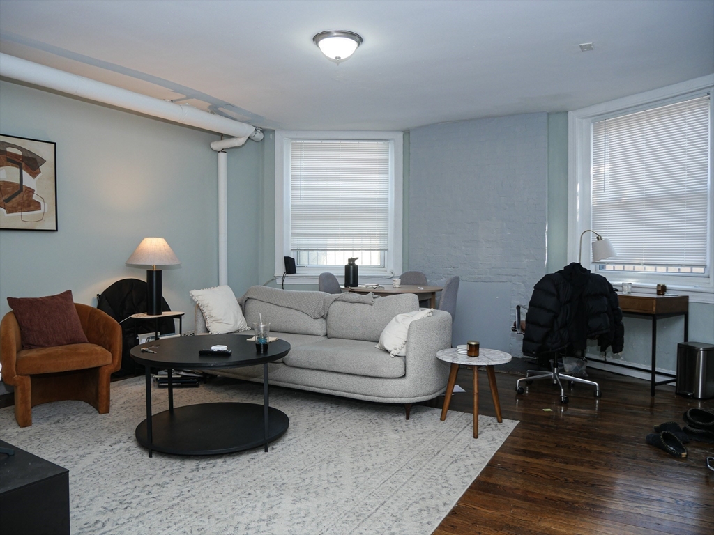 45 Carlton Street, Unit 9 Brookline, MA 02446 - Photo 1 of 8 a living room with furniture a rug and a window