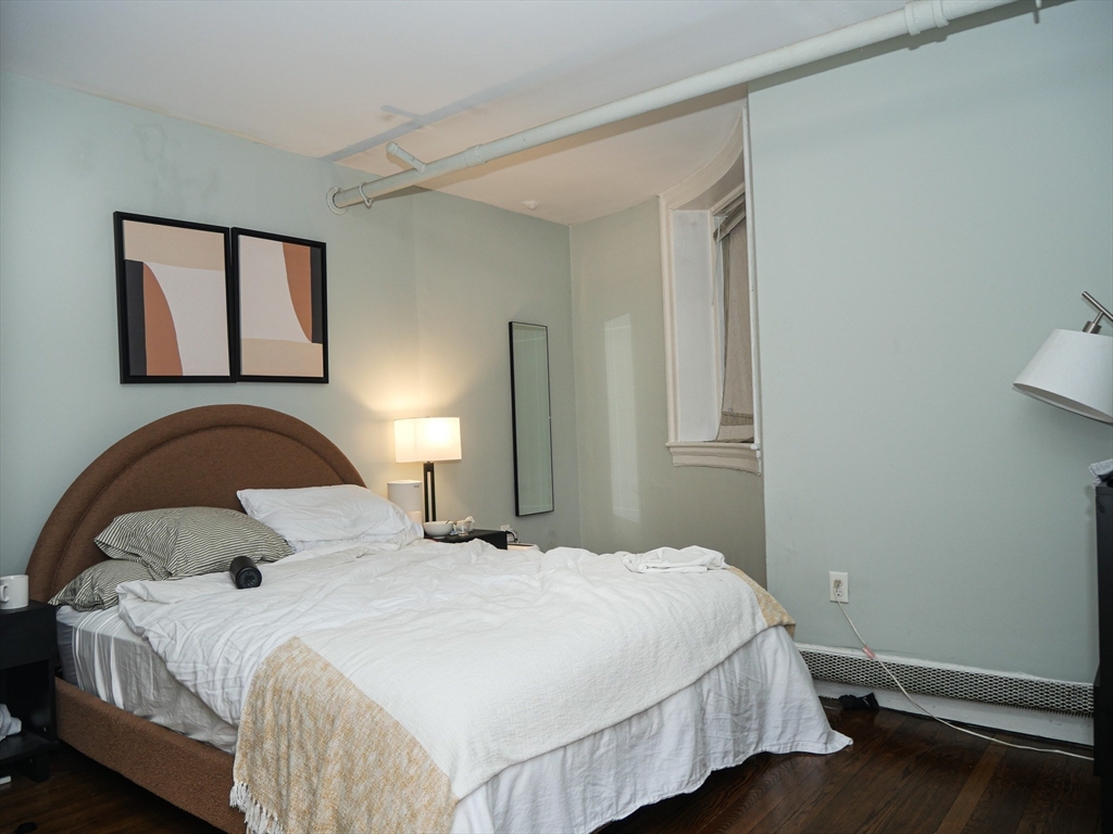 45 Carlton Street, Unit 9 Brookline, MA 02446 - Photo 7 of 8 a bedroom with a bed and window