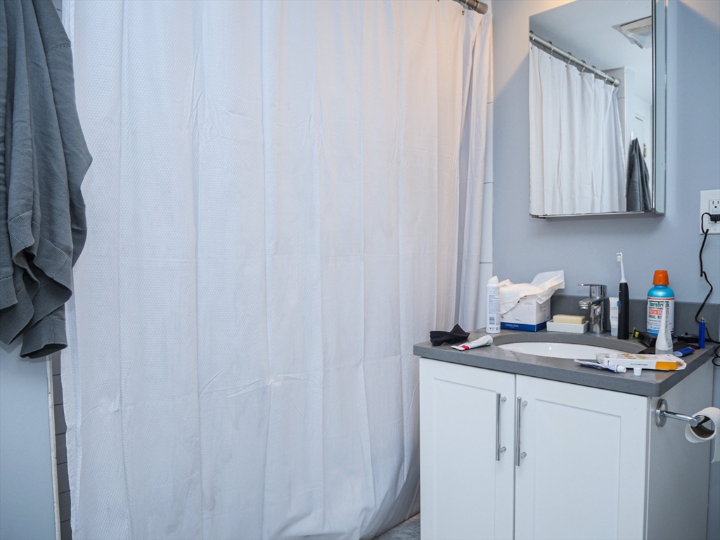 45 Carlton Street, Unit 9 Brookline, MA 02446 - Photo 8 of 8 a kitchen with a sink cabinets and a window