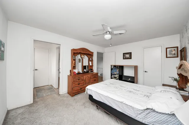 a bedroom with a large bed and a chandelier