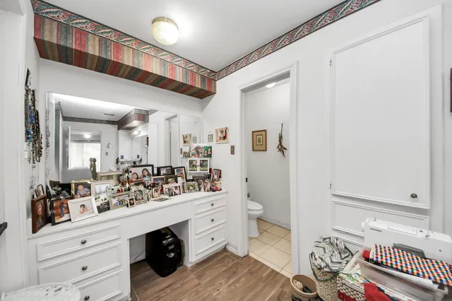 a spacious bathroom with a double vanity sink a mirror and a toilet