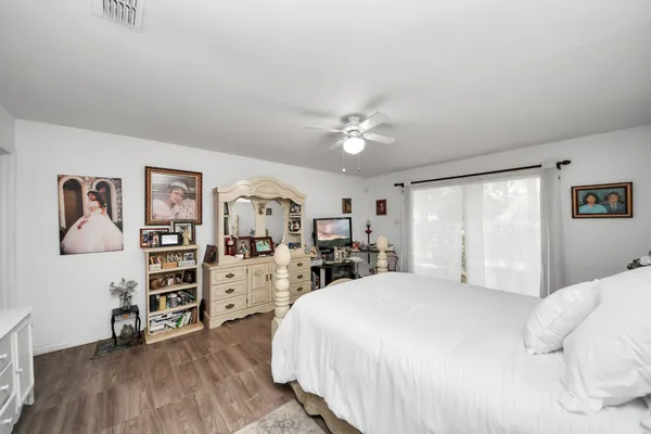 a bedroom with a bed and a large window