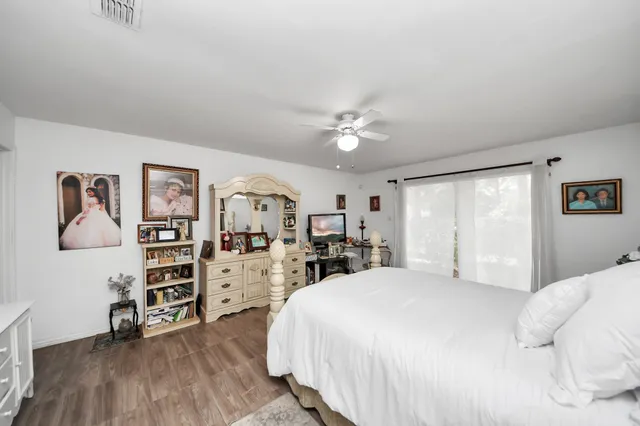 a bedroom with a bed and a large window