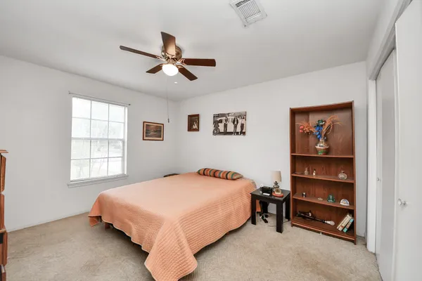 a bedroom with a bed and a window