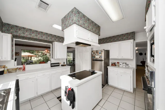 a dining room with furniture a chandelier and window