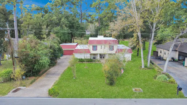 a view of a backyard with table and chairs under an umbrella