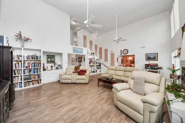 a living room with furniture and a book shelf