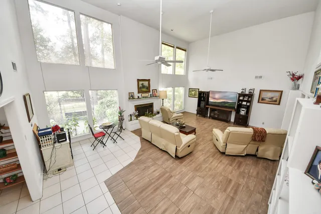 a living room with furniture fireplace and a large window