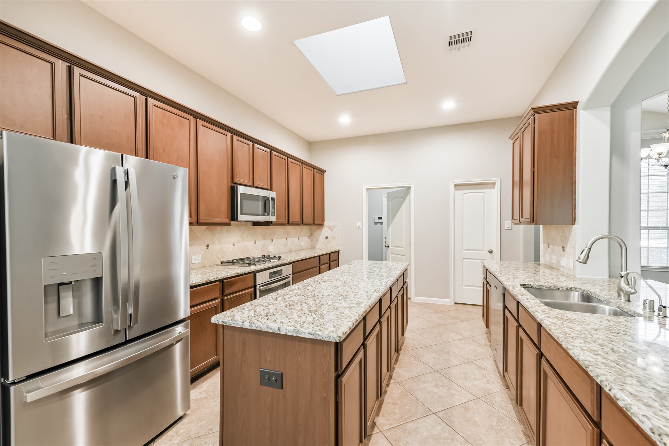 19527 Juniper Breeze Lane Spring, TX 77379 - Photo 12 of 49 a kitchen with stainless steel appliances granite countertop a refrigerator a sink and a stove