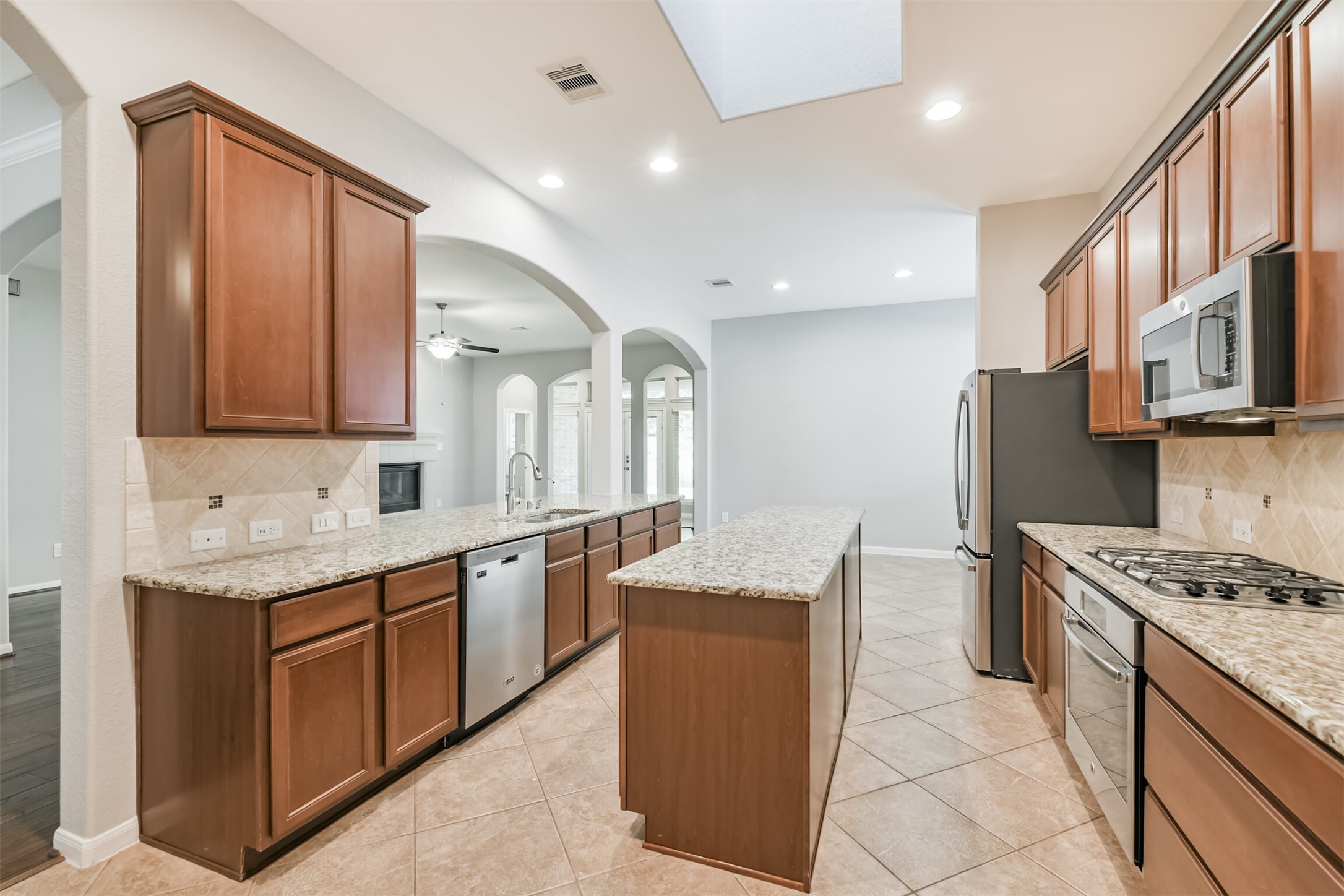 19527 Juniper Breeze Lane Spring, TX 77379 - Photo 14 of 49 a kitchen with stainless steel appliances granite countertop a sink stove and refrigerator