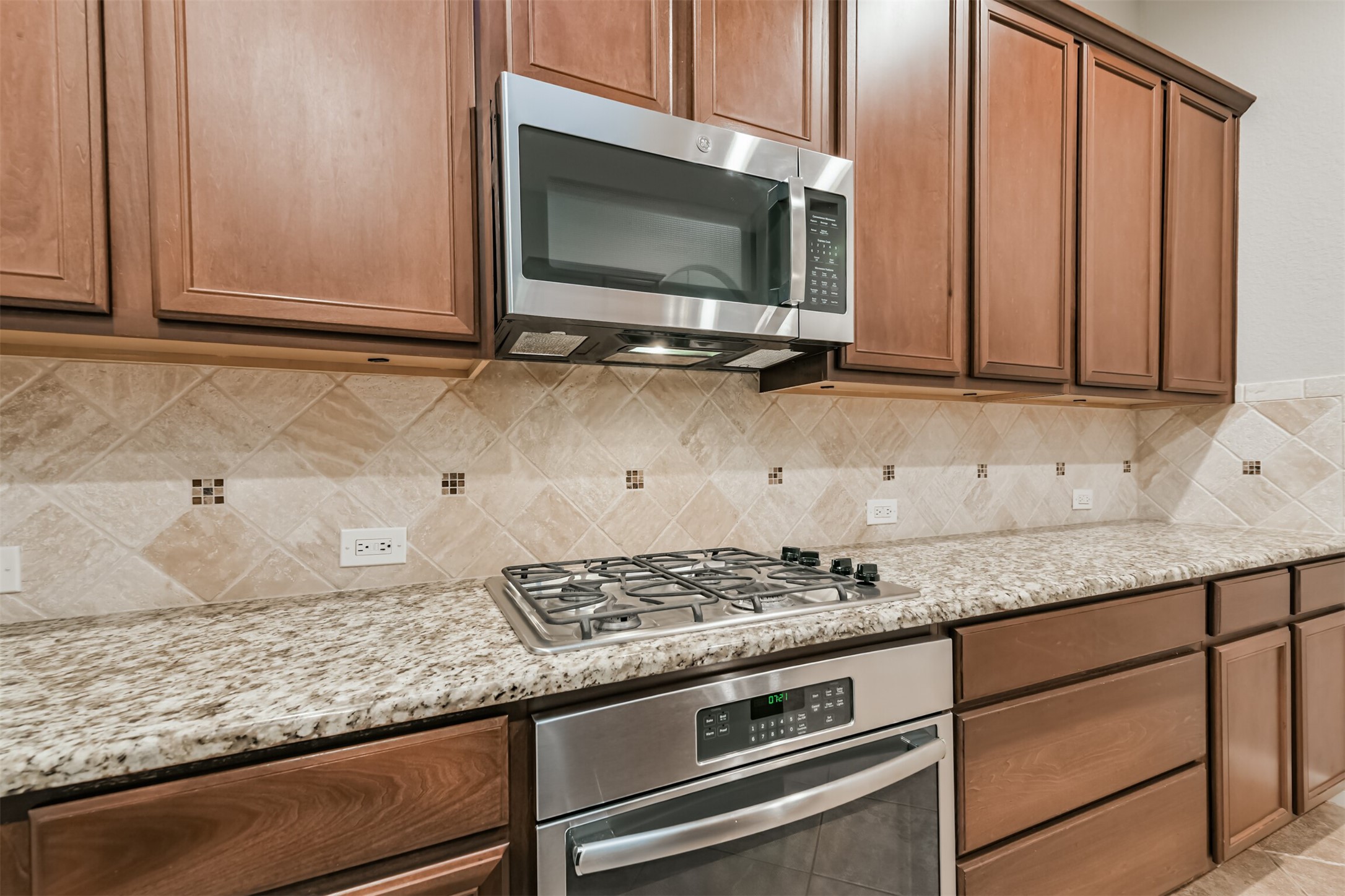19527 Juniper Breeze Lane Spring, TX 77379 - Photo 15 of 49 a kitchen with granite countertop a sink and a microwave