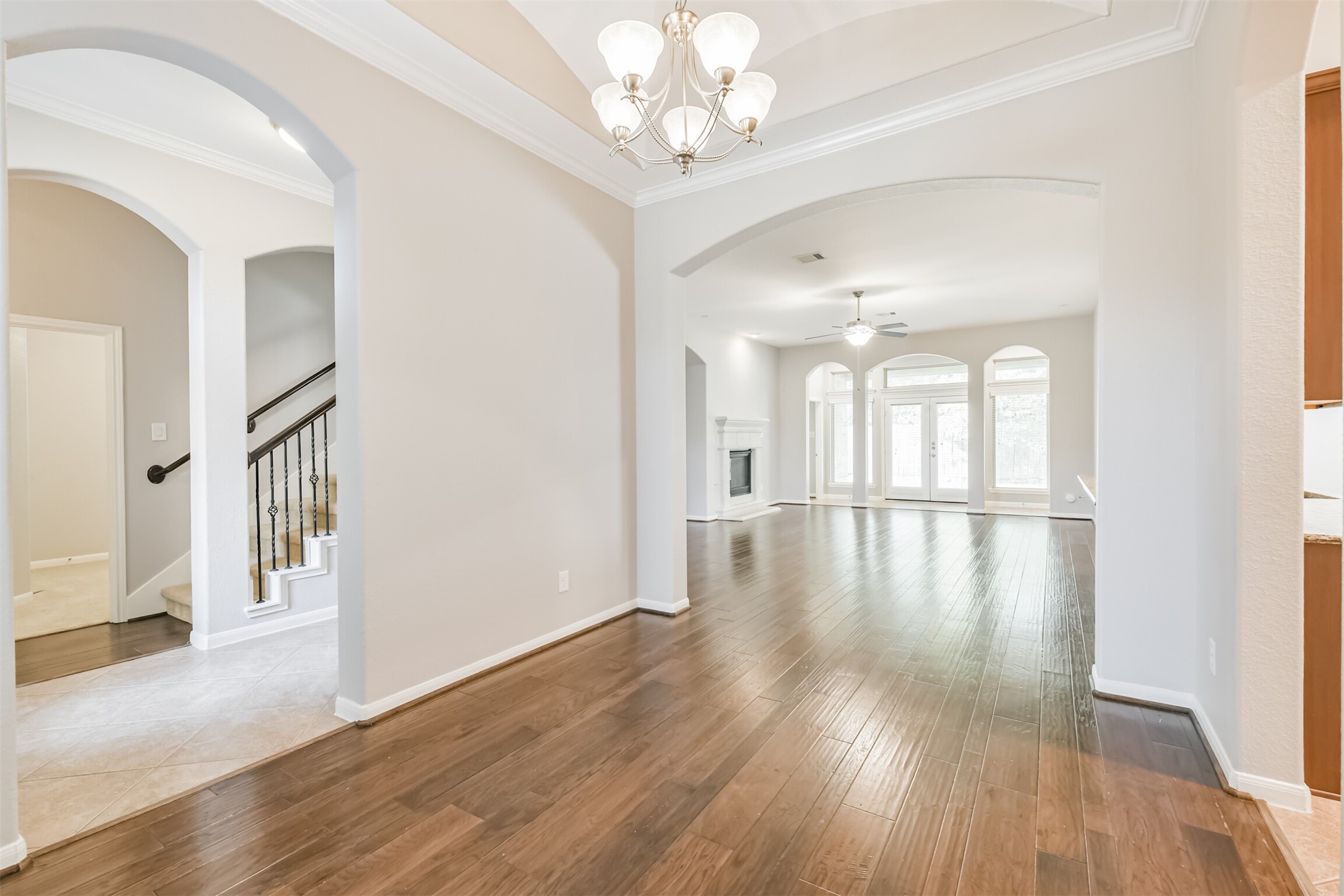 19527 Juniper Breeze Lane Spring, TX 77379 - Photo 21 of 49 a view of a hallway with wooden floor and a chandelier
