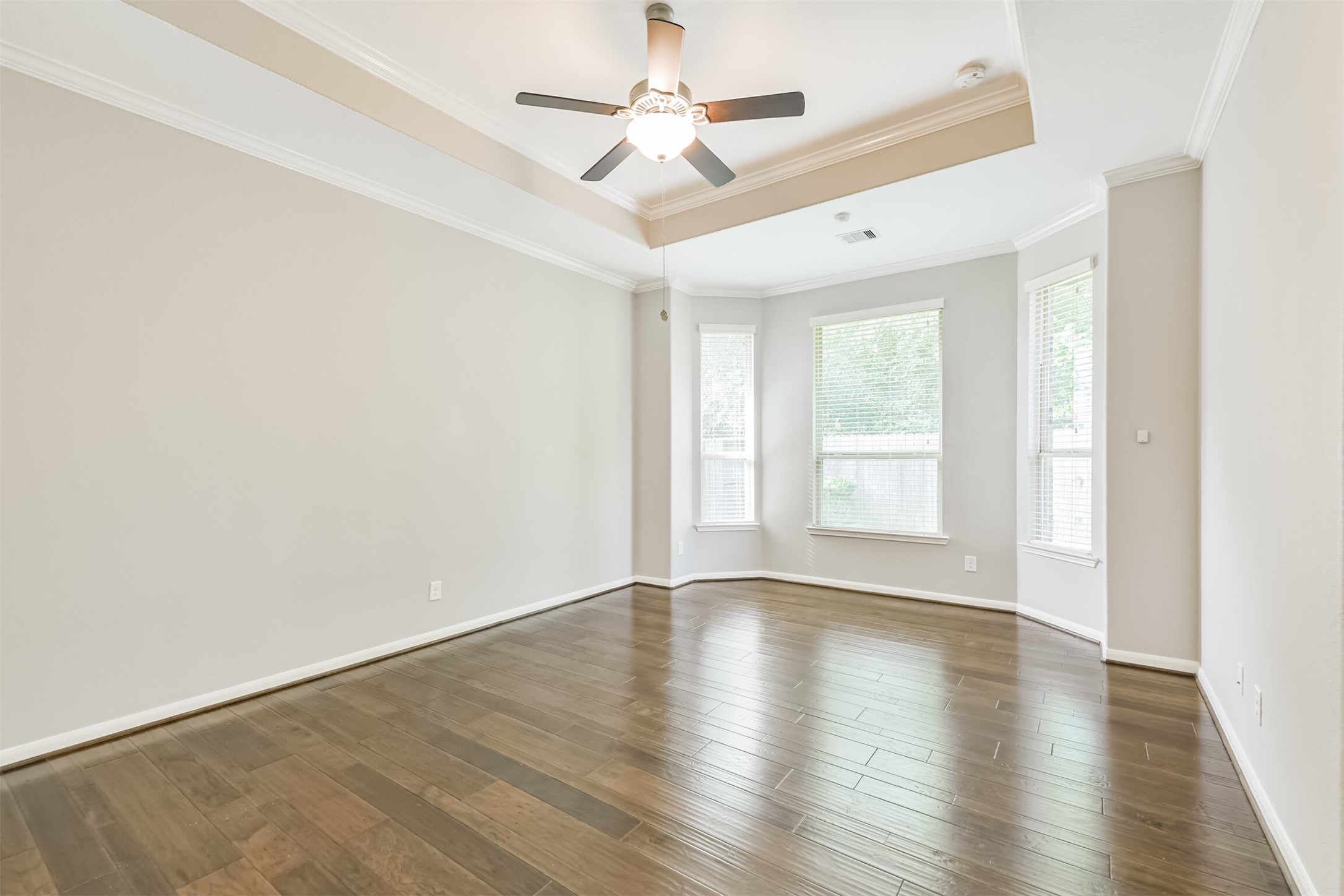 19527 Juniper Breeze Lane Spring, TX 77379 - Photo 22 of 49 a view of an empty room with window and wooden floor