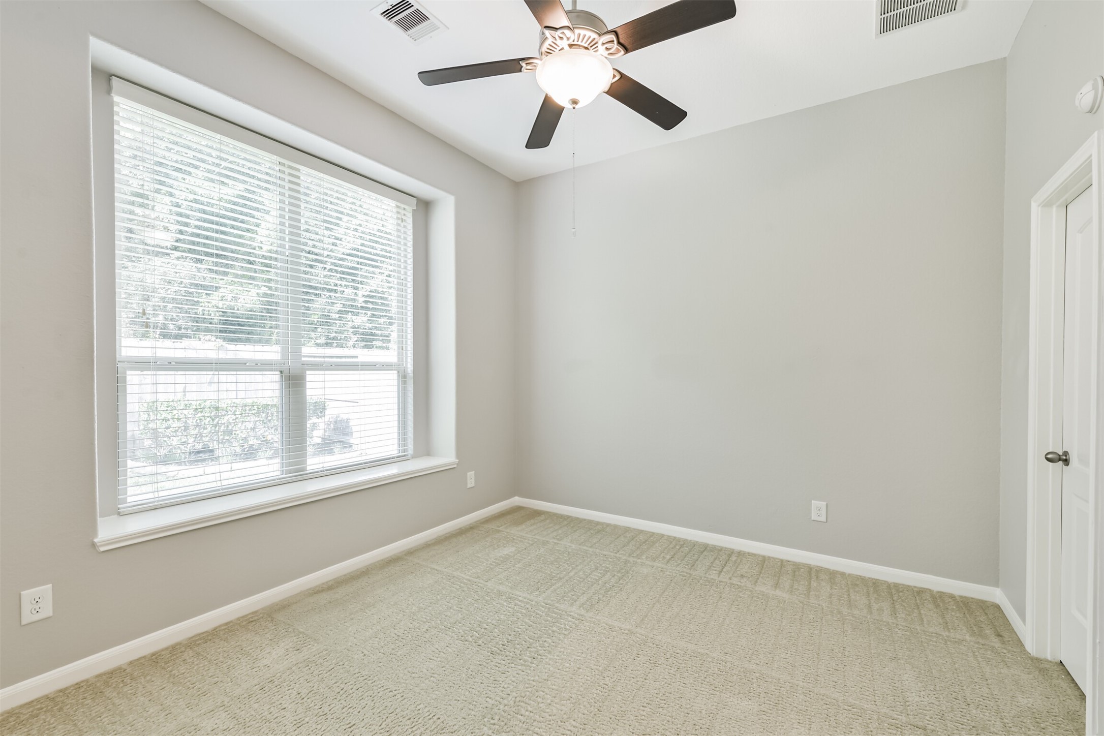 19527 Juniper Breeze Lane Spring, TX 77379 - Photo 28 of 49 an empty room with a window and a fan