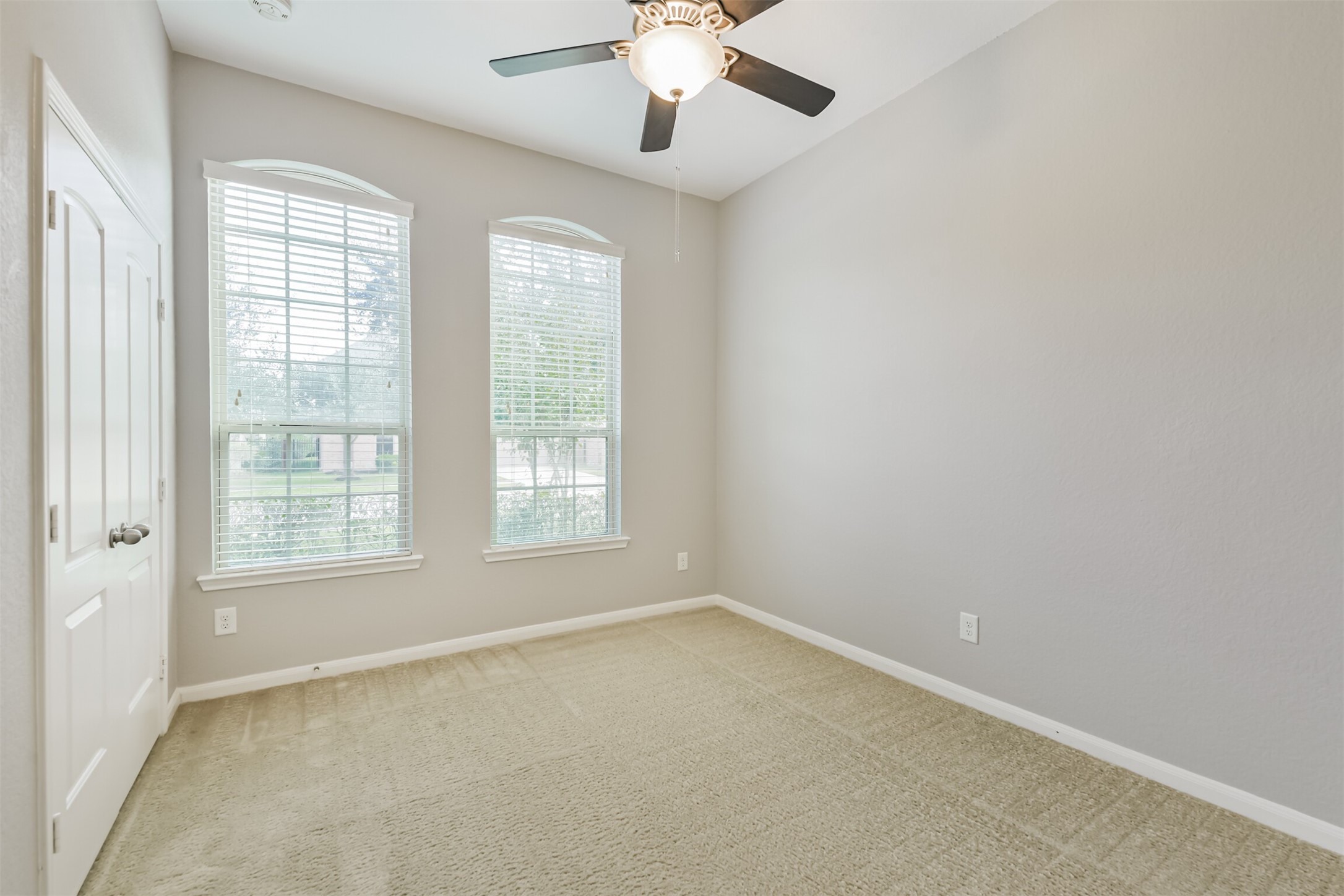19527 Juniper Breeze Lane Spring, TX 77379 - Photo 31 of 49 an empty room with chandelier fan and windows