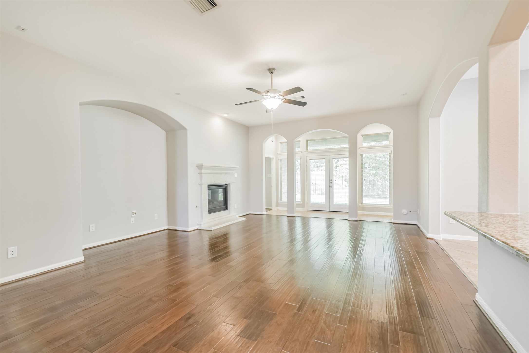 19527 Juniper Breeze Lane Spring, TX 77379 - Photo 8 of 49 wooden floor in an empty room with a window