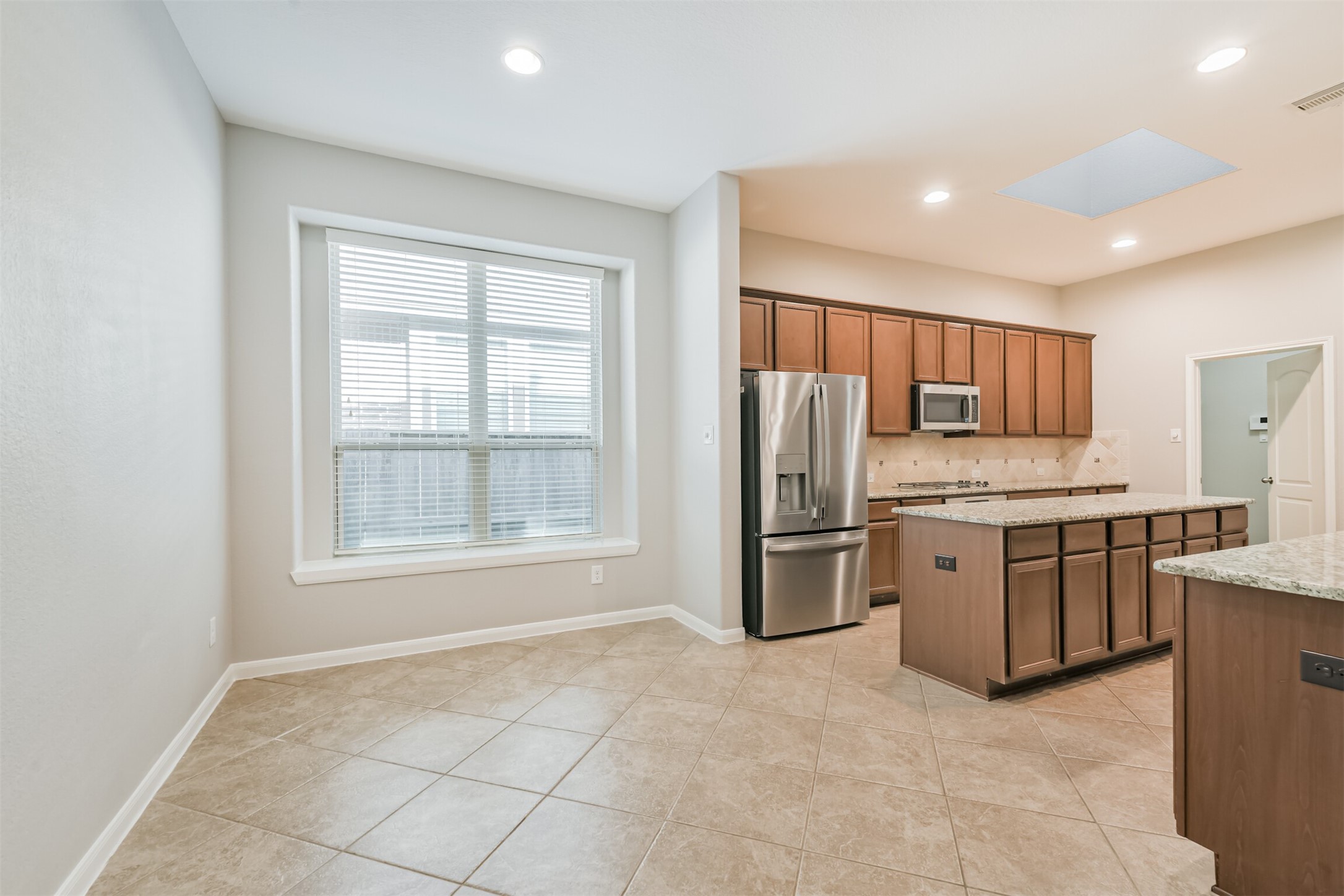 19527 Juniper Breeze Lane Spring, TX 77379 - Photo 10 of 49 a kitchen with stainless steel appliances granite countertop a stove refrigerator and a sink with granite countertops