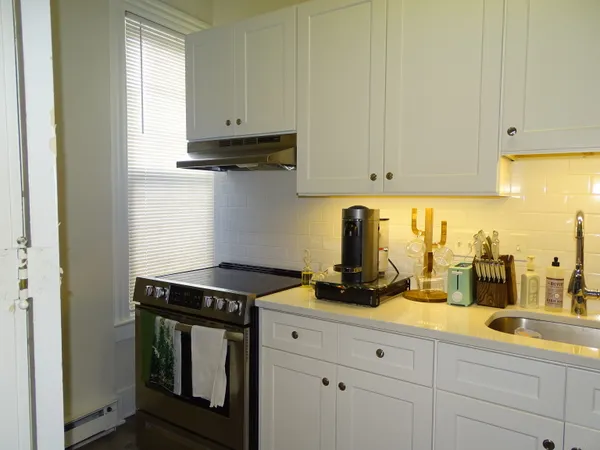 a kitchen with refrigerator and cabinets