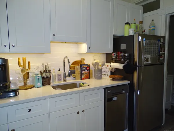 a kitchen with a sink a counter top space and cabinets