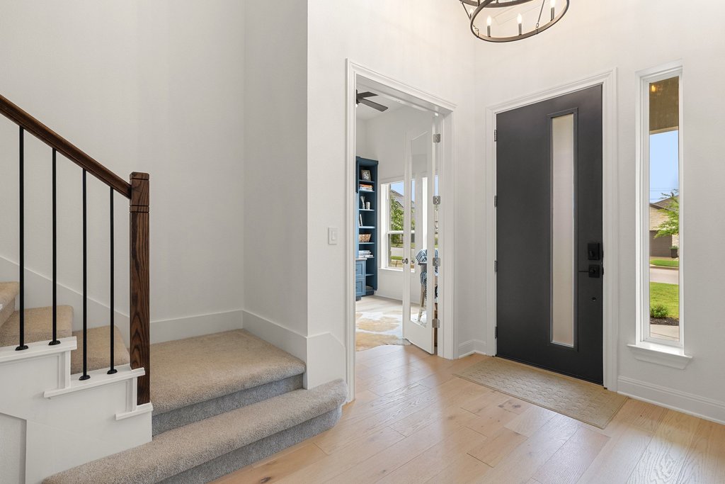 365 Pear Tree Lane Austin, TX 78737 - Photo 5 of 39 a view of a hallway with wooden floor and staircase