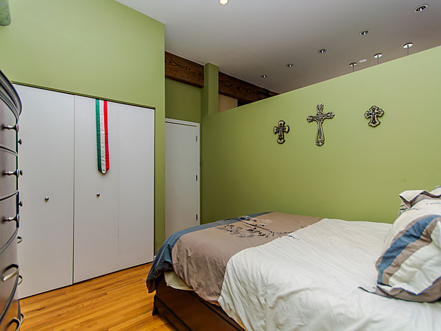 1344 West Madison Street, Unit 303 Chicago, IL 60607 - Photo 13 of 20 a bedroom with a bed and wooden floor