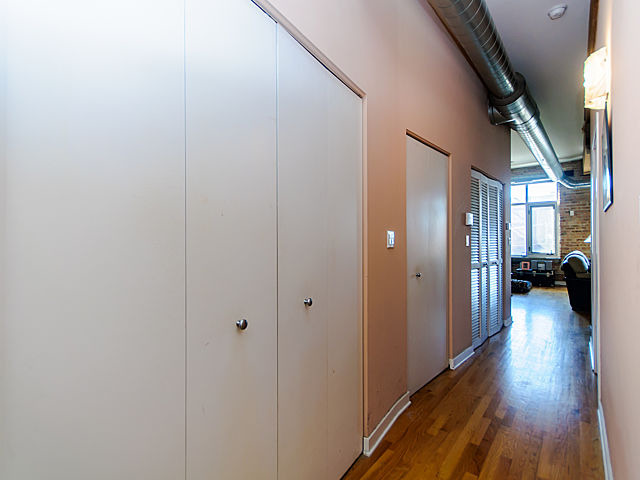1344 West Madison Street, Unit 303 Chicago, IL 60607 - Photo 15 of 20 a view of a hallway with wooden floor and living room