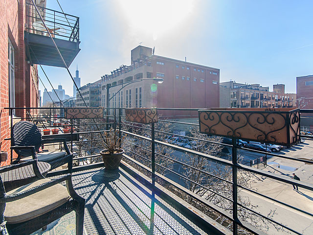 1344 West Madison Street, Unit 303 Chicago, IL 60607 - Photo 17 of 20 a view of a balcony with wooden floor