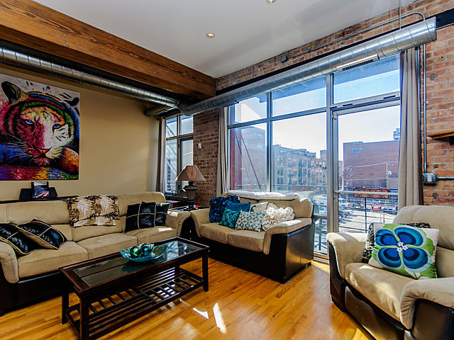 1344 West Madison Street, Unit 303 Chicago, IL 60607 - Photo 3 of 20 a living room with furniture and a large window