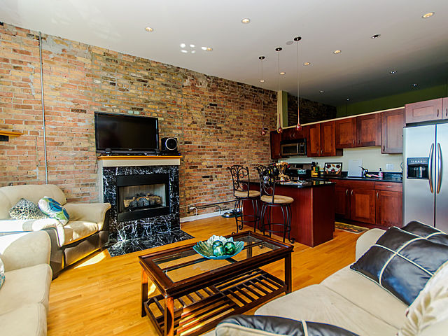 1344 West Madison Street, Unit 303 Chicago, IL 60607 - Photo 4 of 20 a living room with fireplace furniture and a flat screen tv